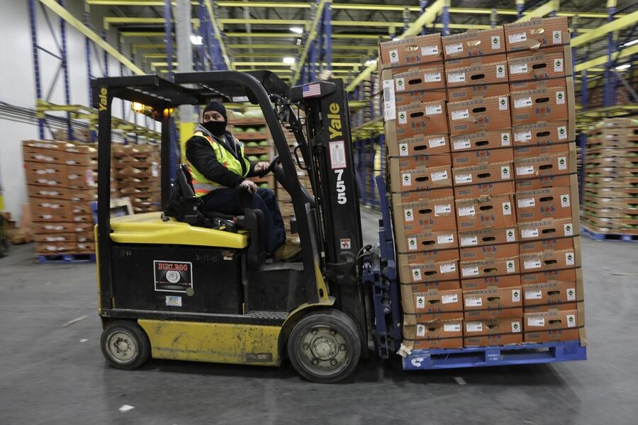 Forklift moving pallets in a warehouse